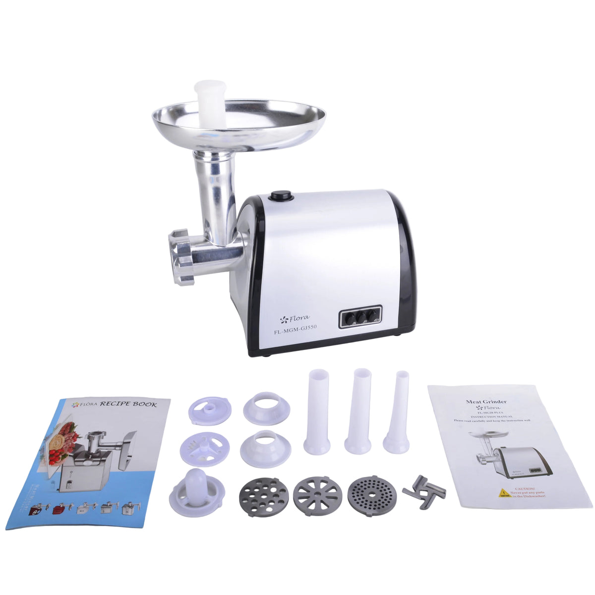 A countertop meat grinder with a white and black body and silver metal hopper, shown on a light gray surface with accessories and two instruction manuals laid out in front.