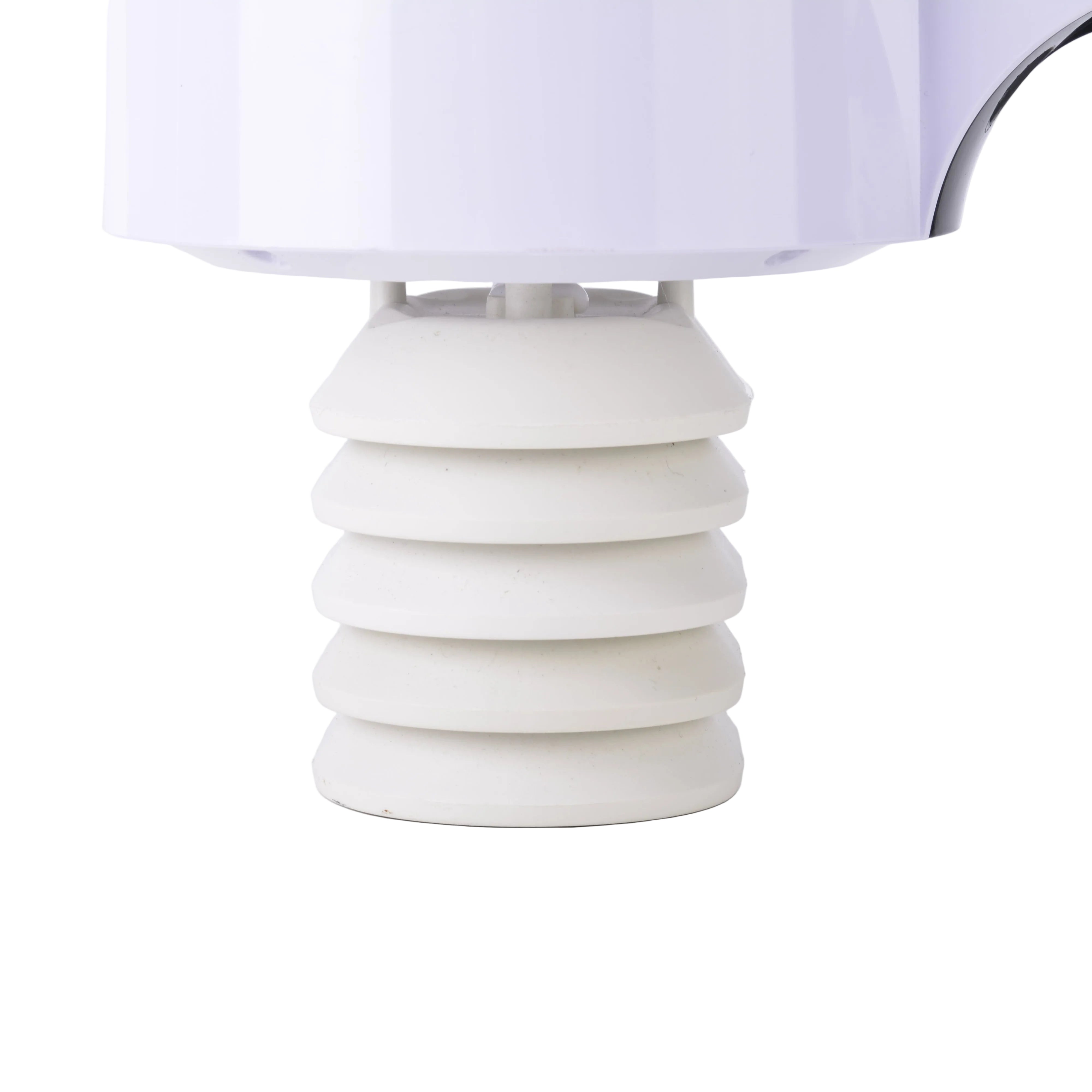 White ceramic table lamp with a ribbed design on a light gray background