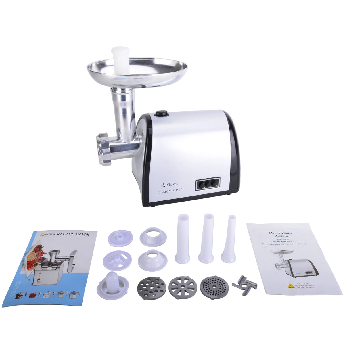 A countertop meat grinder with a white and black body and silver metal hopper, shown on a light gray surface with accessories and two instruction manuals laid out in front.
