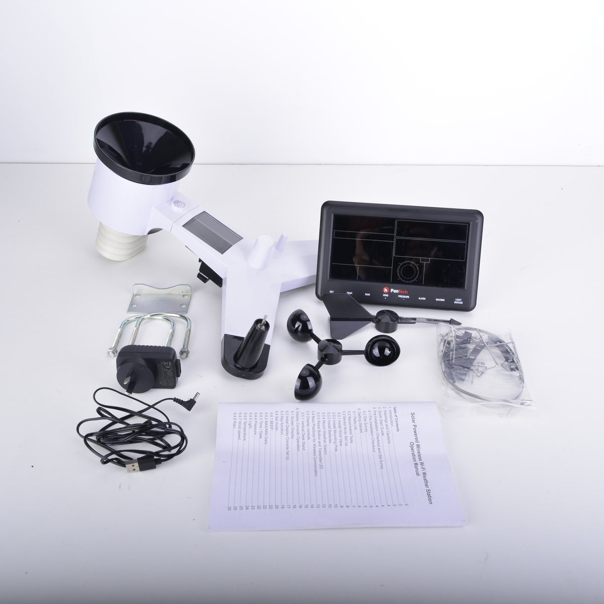 A 3D wind speed and direction measurement kit laid out on a white surface, including a white and black wind vane with a screen, mounting hardware, a power adapter, a USB cable, a printed manual, and accessories.