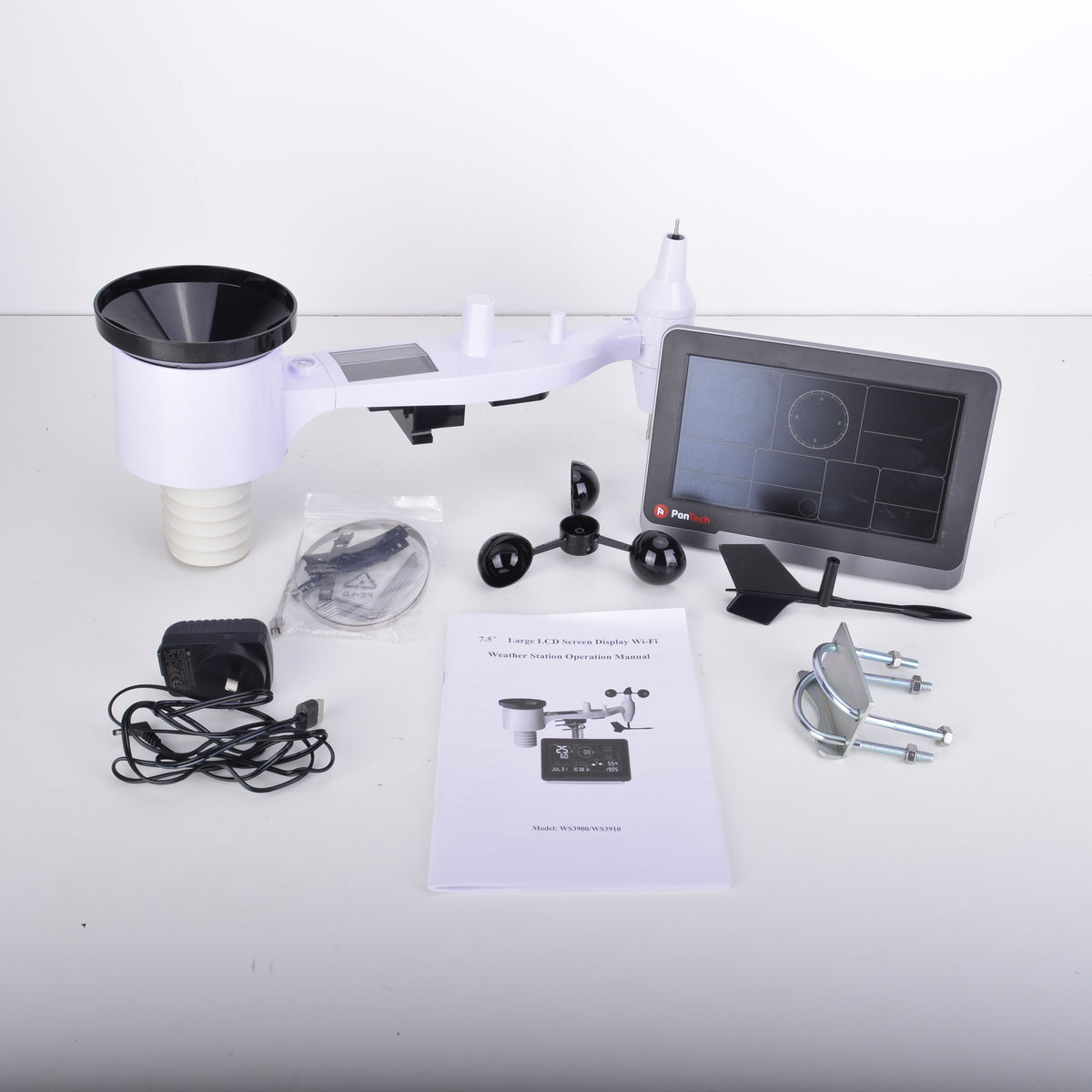 A solar wind speed and direction sensor kit with a white plastic arm, black funnel, digital display screen, mounting hardware, power adapter, cables, and an instruction manual, arranged on a white surface against a white background.